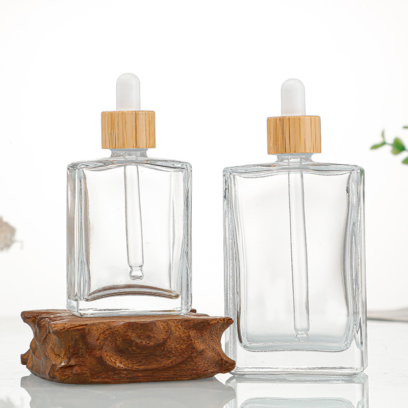 Transparent glass essential oil bottle with bamboo cover lid